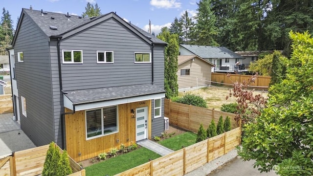 12046 5th Ave NE, Seattle, WA 98125 - back of house with roof with shingles and a fenced backyard