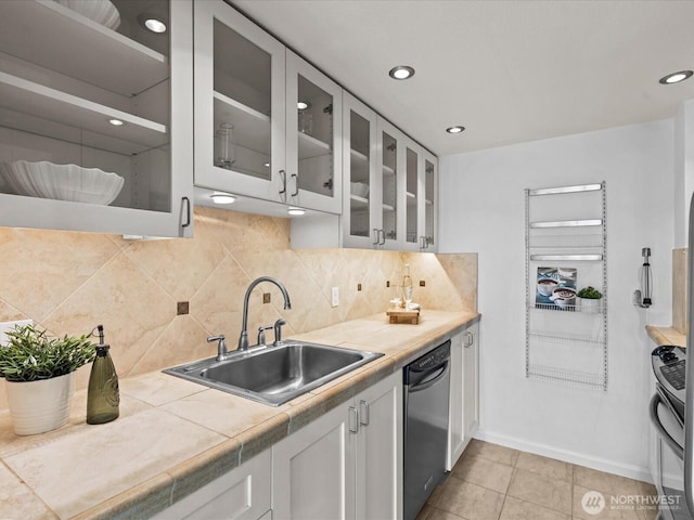 121 Vine St Unit 2405, Seattle, WA 98121 - kitchen featuring stainless steel dishwasher, stove, glass insert cabinets, tasteful backsplash, and white cabinetry