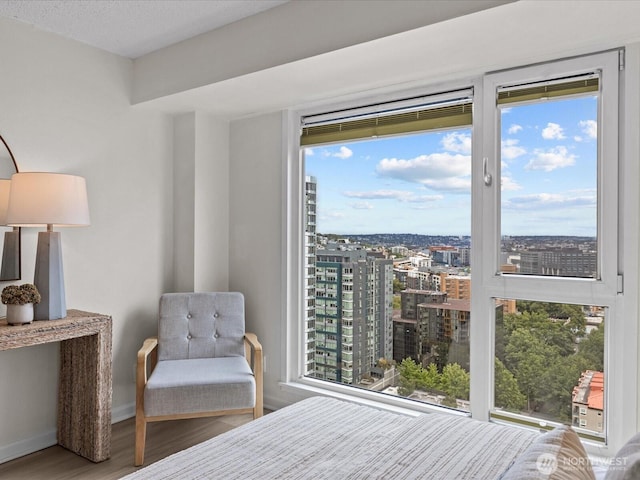 121 Vine St Unit 2405, Seattle, WA 98121 - bedroom with wood finished floors, multiple windows, and a city view