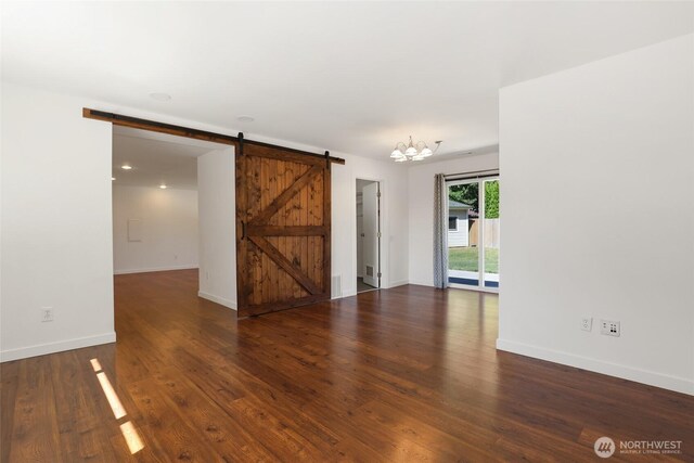 11950 SE 253rd St, Kent, WA 98030 - spare room with a barn door, wood finished floors, and a chandelier