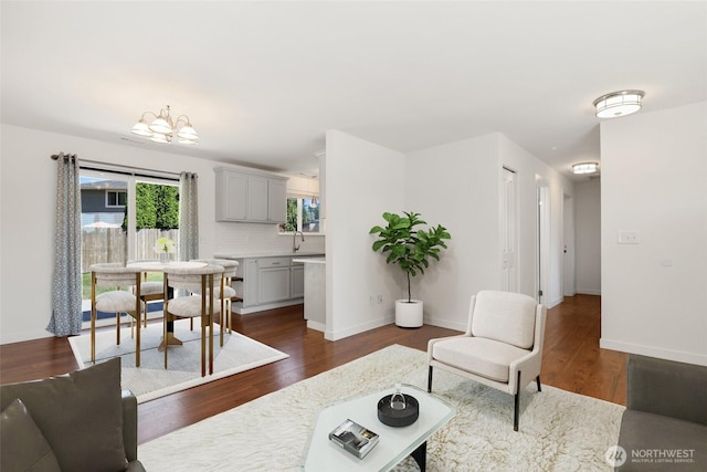 11950 SE 253rd St, Kent, WA 98030 - living room featuring dark wood-style floors and a chandelier