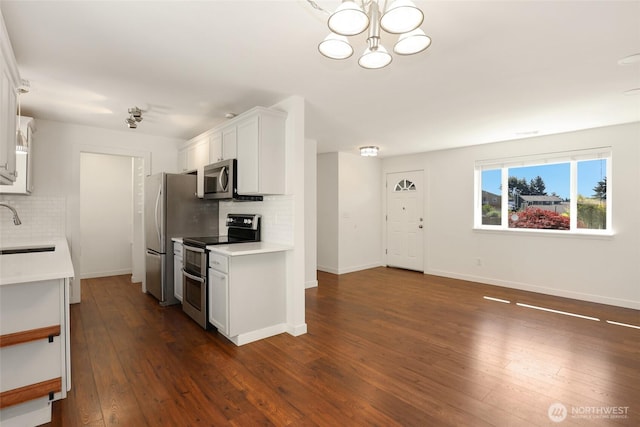 11950 SE 253rd St, Kent, WA 98030 - kitchen with stainless steel appliances, tasteful backsplash, light countertops, and dark wood-type flooring
