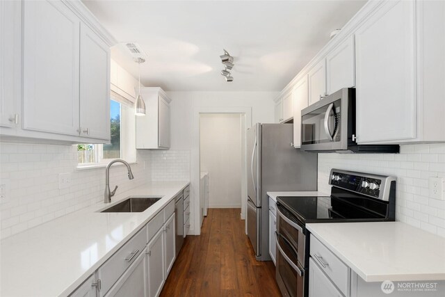 11950 SE 253rd St, Kent, WA 98030 - kitchen featuring appliances with stainless steel finishes, tasteful backsplash, light countertops, and dark wood-style floors