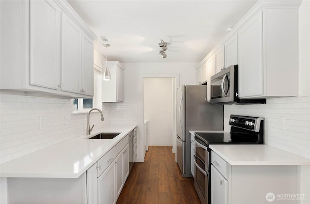 11950 SE 253rd St, Kent, WA 98030 - kitchen featuring stainless steel appliances, backsplash, dark wood-style flooring, light countertops, and white cabinetry