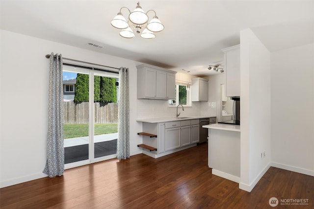 11950 SE 253rd St, Kent, WA 98030 - kitchen featuring gray cabinets, stainless steel dishwasher, light countertops, a chandelier, and backsplash