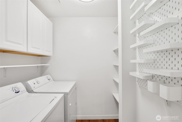 11950 SE 253rd St, Kent, WA 98030 - washroom with washer and clothes dryer, cabinet space, and dark wood-style flooring