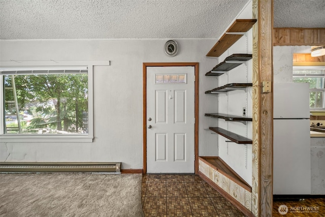 2301 NW Cascade Ave, East Wenatchee, WA 98802 - entrance foyer featuring a textured ceiling and a baseboard heating unit