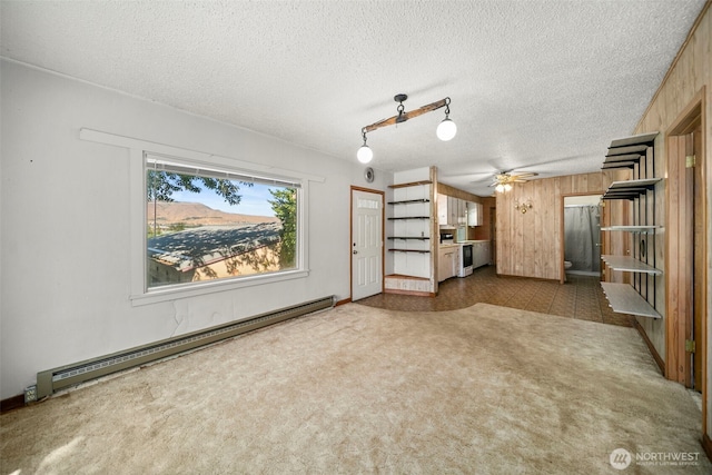 2301 NW Cascade Ave, East Wenatchee, WA 98802 - unfurnished living room featuring a baseboard radiator, ceiling fan, and a textured ceiling