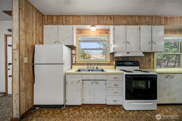 2301 NW Cascade Ave, East Wenatchee, WA 98802 - kitchen with freestanding refrigerator, electric range oven, a textured ceiling, light countertops, and white cabinetry
