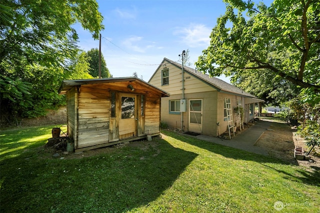 2301 NW Cascade Ave, East Wenatchee, WA 98802 - rear view of property featuring a lawn and a shed