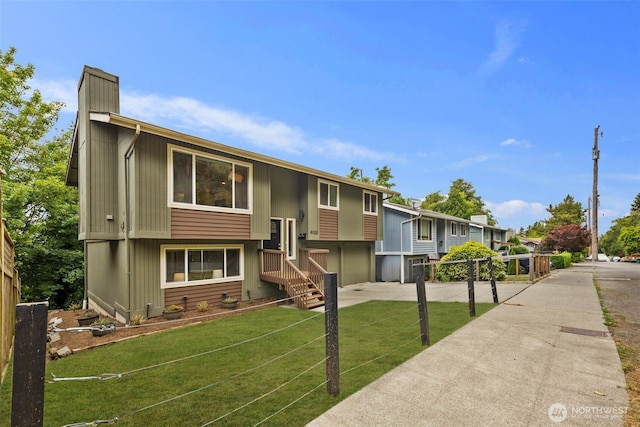 4133 23rd Ave SW, Seattle, WA 98106 - bi-level home featuring a chimney, a front yard, and driveway