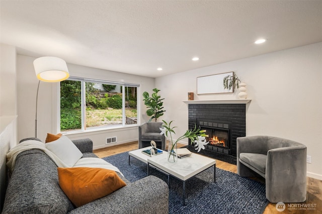 4133 23rd Ave SW, Seattle, WA 98106 - living room with wood finished floors, a fireplace, and recessed lighting