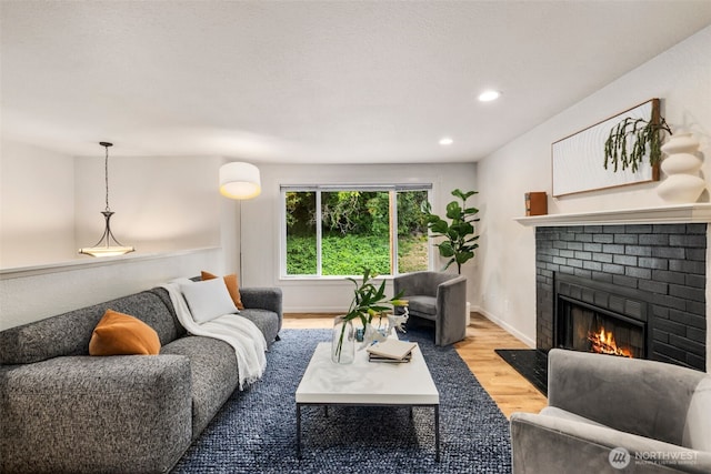 4133 23rd Ave SW, Seattle, WA 98106 - living area with a fireplace, wood finished floors, and recessed lighting
