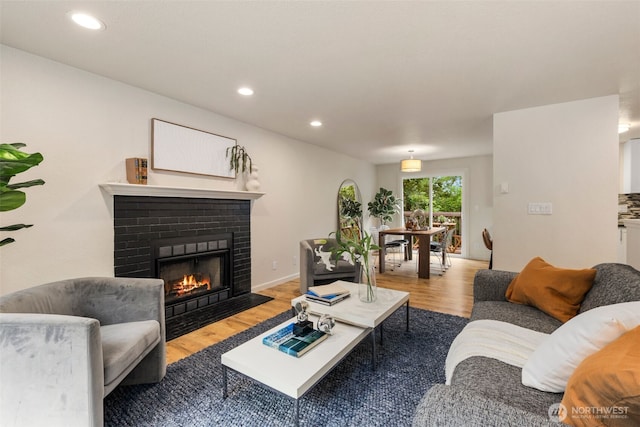4133 23rd Ave SW, Seattle, WA 98106 - living area with wood finished floors, a brick fireplace, and recessed lighting