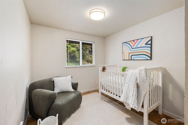 4133 23rd Ave SW, Seattle, WA 98106 - bedroom with wood finished floors and a nursery area
