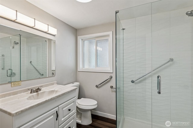1524 26th Ave NE, Olympia, WA 98506 - full bathroom featuring vanity, a stall shower, and wood finished floors
