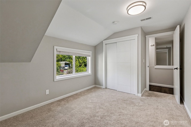 1524 26th Ave NE, Olympia, WA 98506 - unfurnished bedroom with lofted ceiling, carpet flooring, and a closet