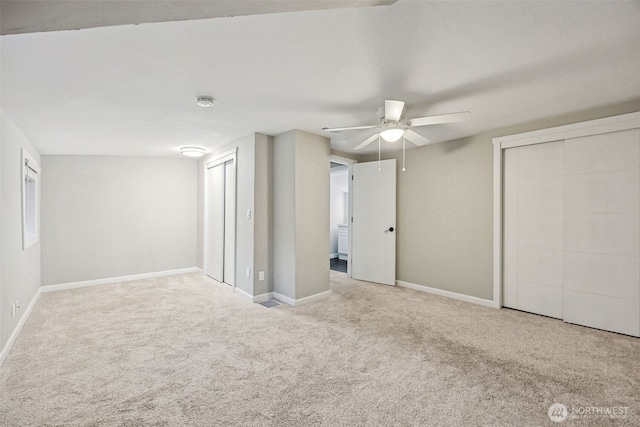 1524 26th Ave NE, Olympia, WA 98506 - unfurnished bedroom featuring carpet floors, a ceiling fan, and two closets