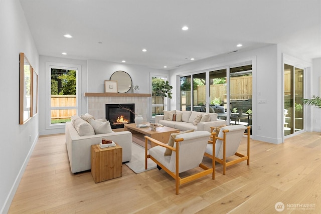 233 19th Ave, Kirkland, WA 98033 - living area with recessed lighting, a tiled fireplace, light wood-type flooring, and plenty of natural light