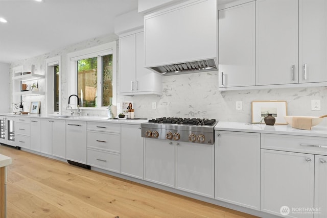 233 19th Ave, Kirkland, WA 98033 - kitchen with stainless steel gas cooktop, custom range hood, white cabinets, light countertops, and tasteful backsplash
