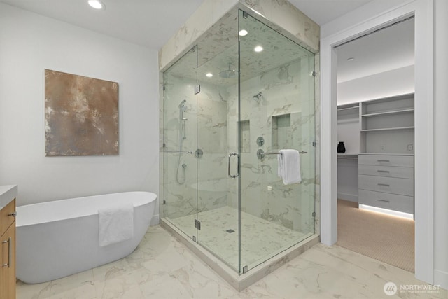 233 19th Ave, Kirkland, WA 98033 - bathroom with a marble finish shower, recessed lighting, a freestanding bath, marble finish flooring, and a walk in closet