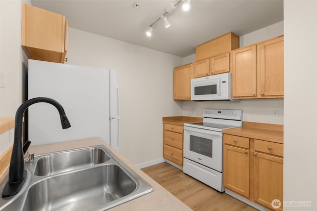 6409 Hazel Ln SE Unit H, Auburn, WA 98092 - kitchen with white appliances, light wood-style flooring, light brown cabinets, and light countertops