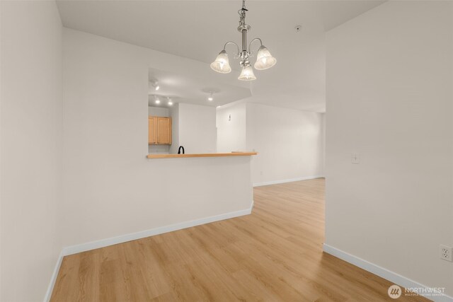 6409 Hazel Ln SE Unit H, Auburn, WA 98092 - spare room with light wood-type flooring and a chandelier