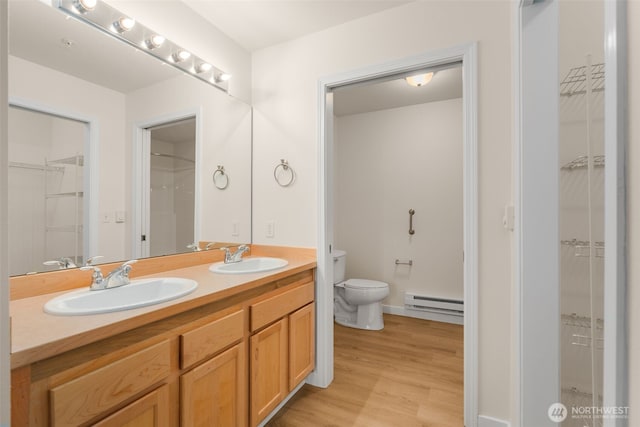 6409 Hazel Ln SE Unit H, Auburn, WA 98092 - full bath with baseboard heating, a walk in closet, double vanity, and wood finished floors
