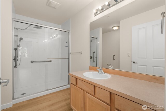 6409 Hazel Ln SE Unit H, Auburn, WA 98092 - bathroom featuring a shower stall, vanity, and wood finished floors