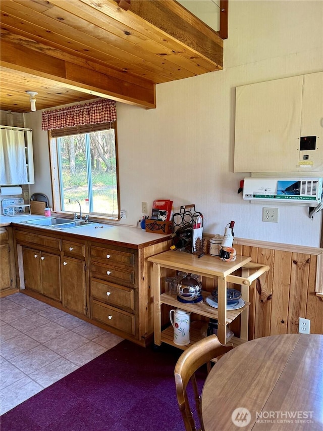 108 N Airport Way, Friday Harbor, WA 98250 - kitchen featuring a wooden ceiling with exposed beams, brown cabinetry, light tile patterned floors, and light countertops