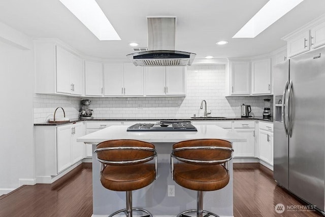 1501 58th Ave NE, Tacoma, WA 98422 - kitchen with appliances with stainless steel finishes, a skylight, island exhaust hood, dark wood-style flooring, and recessed lighting