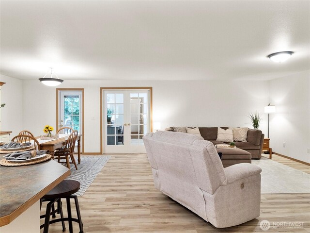 15428 Bornstein Ln SE, Yelm, WA 98597 - living room featuring light wood finished floors and french doors