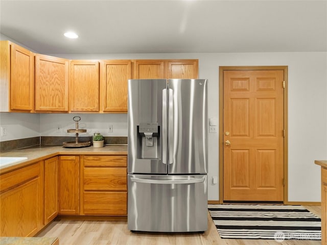 15428 Bornstein Ln SE, Yelm, WA 98597 - kitchen with stainless steel fridge, light wood finished floors, and recessed lighting