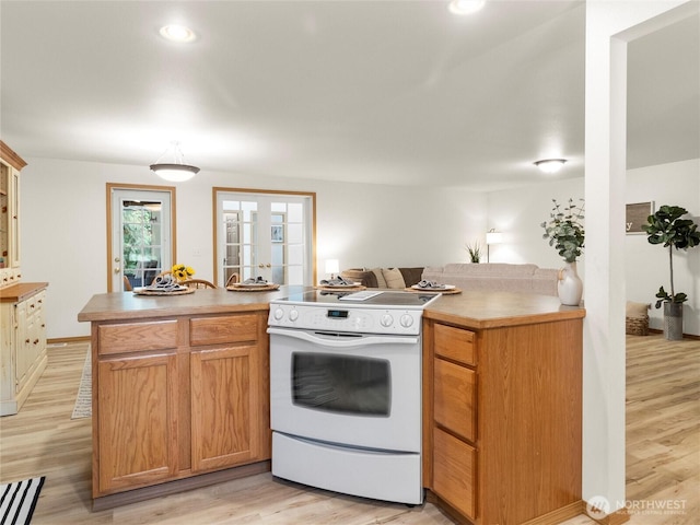 15428 Bornstein Ln SE, Yelm, WA 98597 - kitchen featuring white range with electric stovetop, light wood-type flooring, recessed lighting, and light countertops