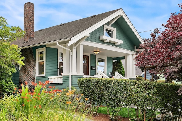 4010 Interlake Ave N, Seattle, WA 98103 - bungalow-style house with a chimney, a shingled roof, and covered porch