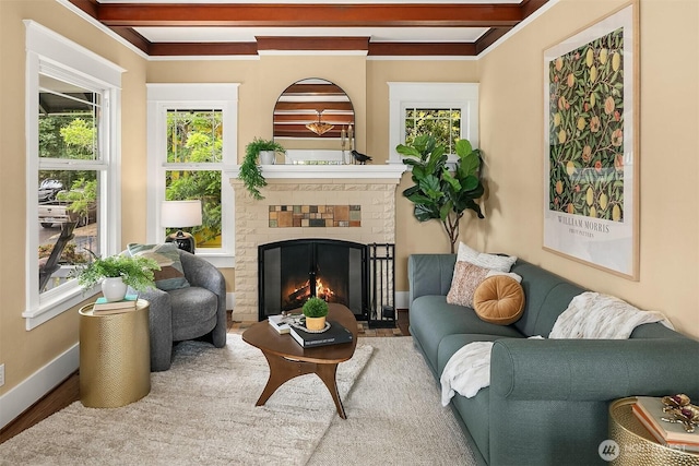 4010 Interlake Ave N, Seattle, WA 98103 - living room featuring plenty of natural light, a brick fireplace, beamed ceiling, and wood finished floors