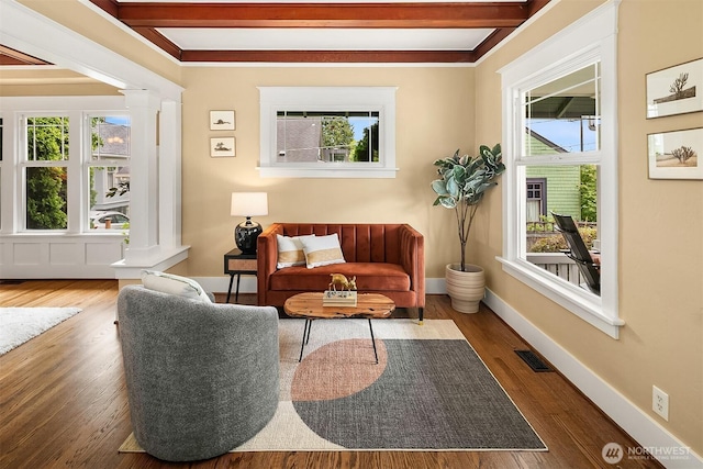 4010 Interlake Ave N, Seattle, WA 98103 - sitting room featuring decorative columns, healthy amount of natural light, wood finished floors, and beamed ceiling