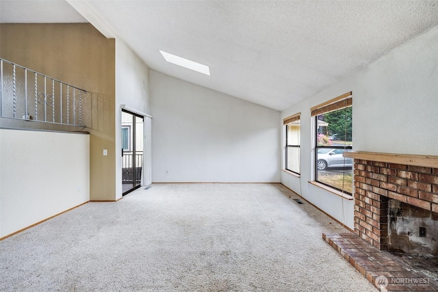31107 11th Pl SW, Federal Way, WA 98023 - unfurnished living room featuring a brick fireplace, carpet flooring, a skylight, a textured ceiling, and high vaulted ceiling