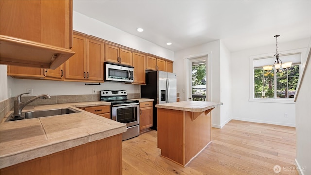 208 Sagebrook Ln, Cle Elum, WA 98922 - kitchen with stainless steel appliances, light countertops, light wood-type flooring, hanging light fixtures, and a chandelier