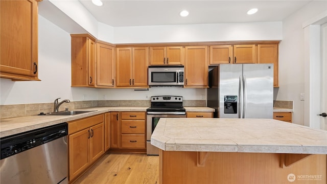 208 Sagebrook Ln, Cle Elum, WA 98922 - kitchen featuring appliances with stainless steel finishes, light countertops, a kitchen bar, light wood-style floors, and recessed lighting