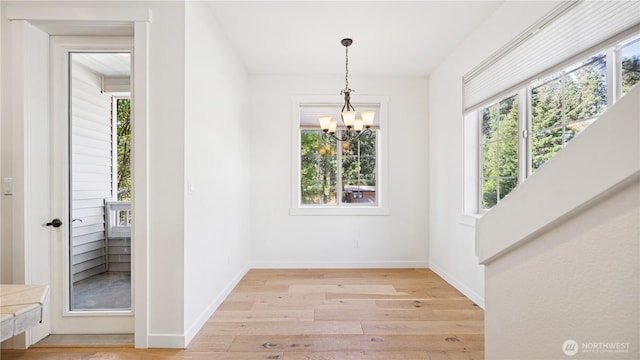 208 Sagebrook Ln, Cle Elum, WA 98922 - unfurnished dining area featuring healthy amount of natural light, a chandelier, and light wood-style flooring
