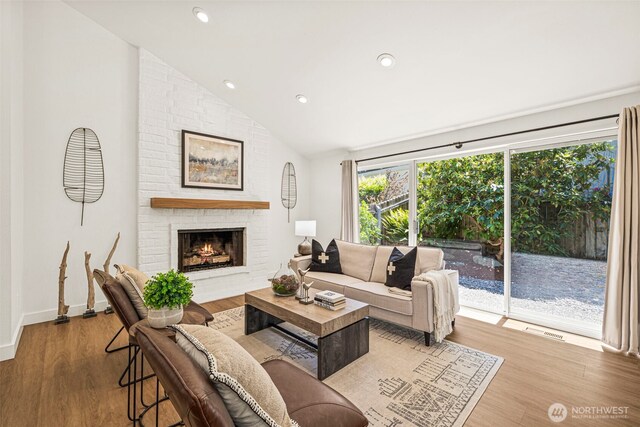 6401 146th Ave NE, Redmond, WA 98052 - living room with vaulted ceiling, a brick fireplace, wood finished floors, and recessed lighting