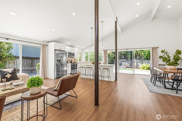 6401 146th Ave NE, Redmond, WA 98052 - living area featuring beamed ceiling, light wood-style floors, healthy amount of natural light, high vaulted ceiling, and recessed lighting