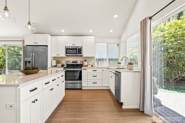 6401 146th Ave NE, Redmond, WA 98052 - kitchen with appliances with stainless steel finishes, healthy amount of natural light, light countertops, recessed lighting, and hanging light fixtures