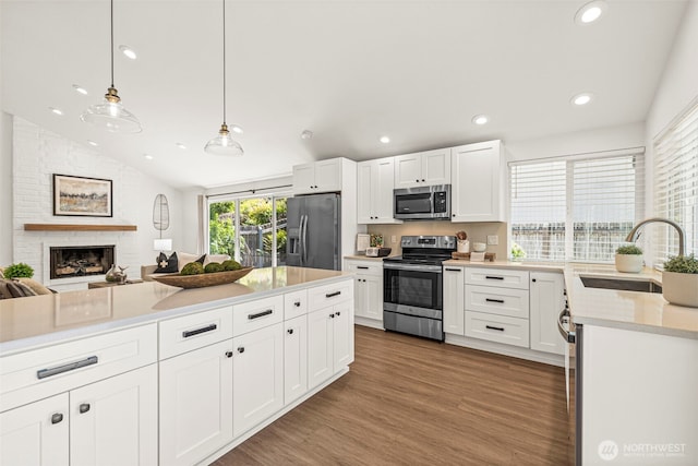 6401 146th Ave NE, Redmond, WA 98052 - kitchen featuring appliances with stainless steel finishes, lofted ceiling, light countertops, white cabinetry, and recessed lighting