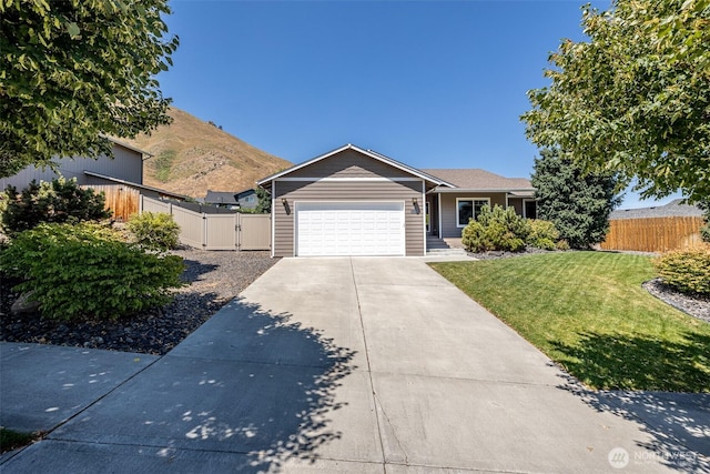 2124 Citation Loop, Wenatchee, WA 98801 - ranch-style home featuring a gate, concrete driveway, an attached garage, and a mountain view