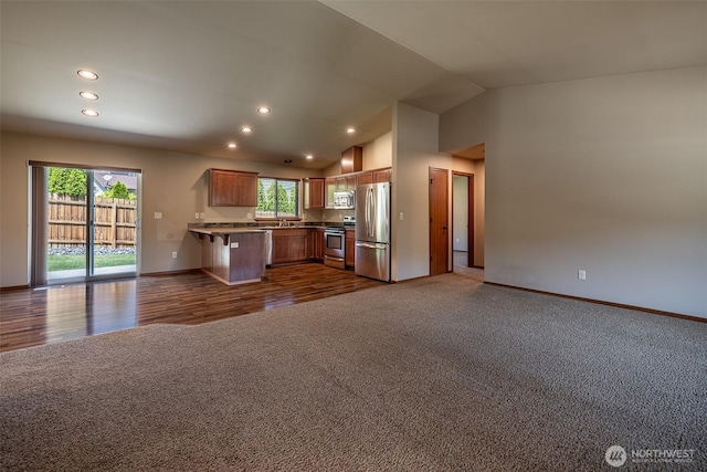 2124 Citation Loop, Wenatchee, WA 98801 - kitchen with appliances with stainless steel finishes, open floor plan, dark carpet, recessed lighting, and a peninsula