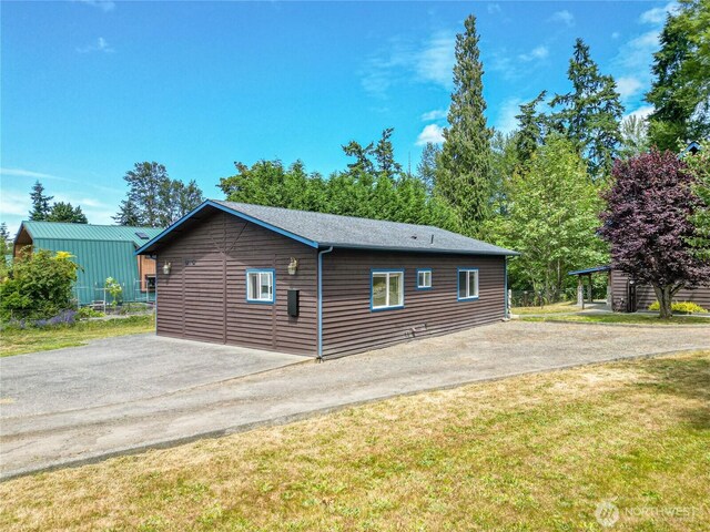 71 Waggler Way, Sequim, WA 98382 - view of property exterior with asphalt driveway, a yard, and a patio area