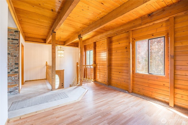 71 Waggler Way, Sequim, WA 98382 - empty room featuring a wood ceiling with exposed beams, wood finished floors, wooden walls, and a chandelier