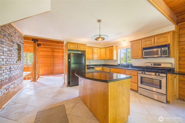 71 Waggler Way, Sequim, WA 98382 - kitchen featuring appliances with stainless steel finishes, dark countertops, a center island, light tile patterned flooring, and hanging light fixtures